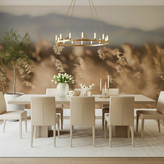 Whispers of the Field wallpaper mural of golden reeds and blue hills in a dining room with a beige table and cream chairs