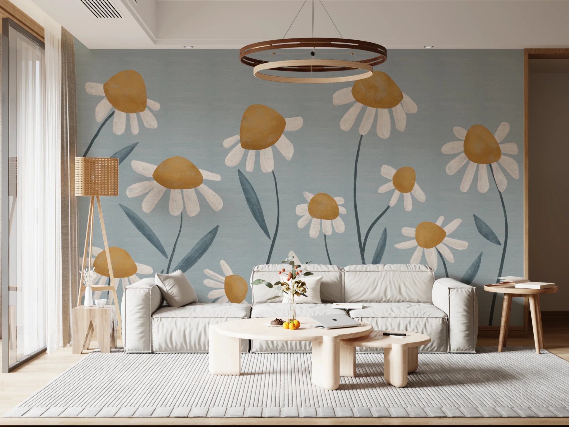 Sunny Daisy Field wallpaper mural of white and ochre daisies on dusty blue behind a grey sofa in a living room