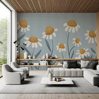 Sunny Daisy Field wallpaper mural of white daisies on dusty blue behind a grey sectional and swivel chairs in a living room