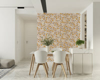 A cheerful floral wallpaper featuring small mustard yellow blooms on a soft beige background.