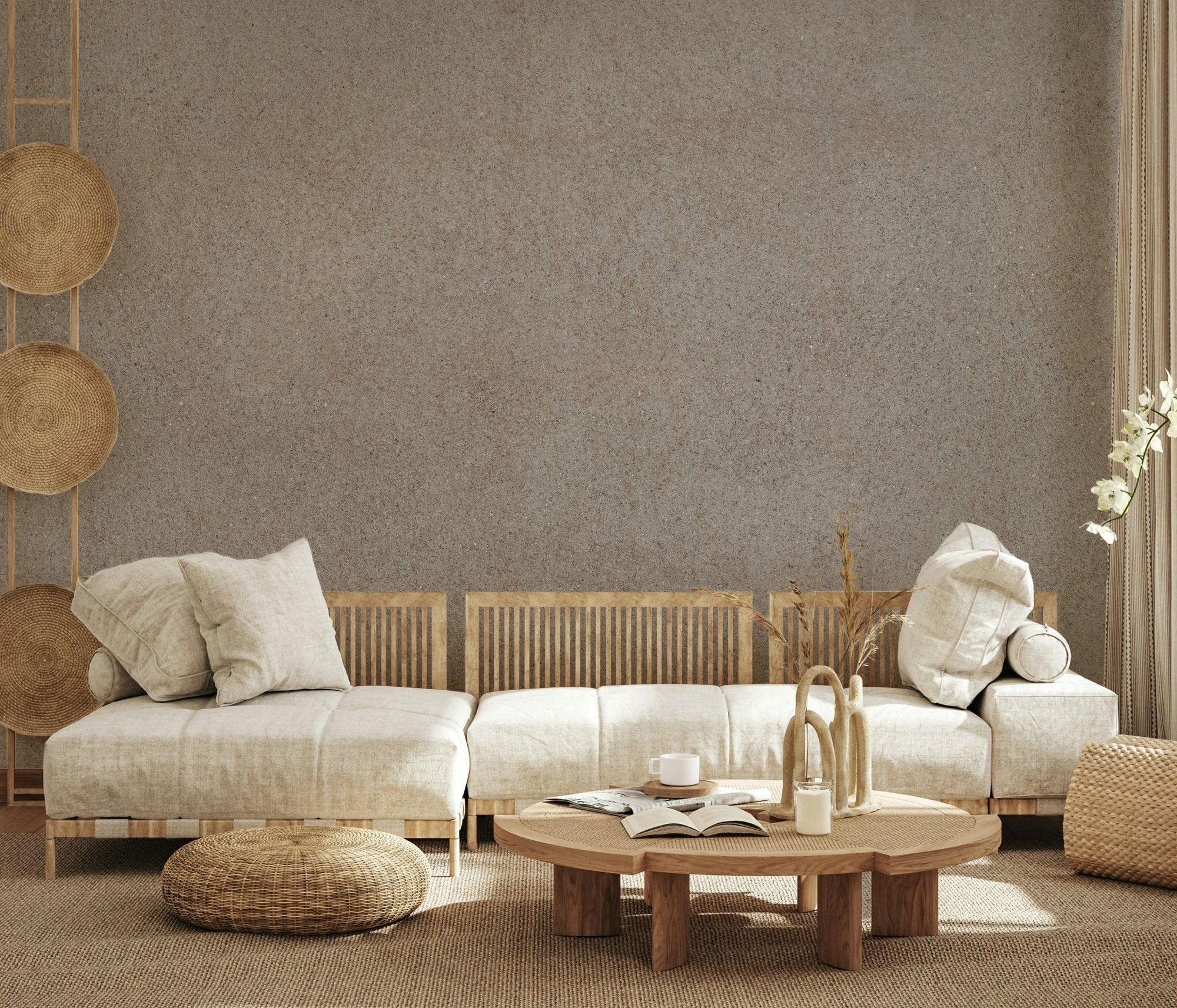 Taupe Stone Surface wallpaper mural behind a beige sofa and round wood table in a boho living room