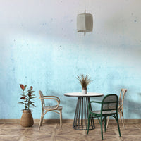 Wall mural with a teal ombre on a concrete texture.

