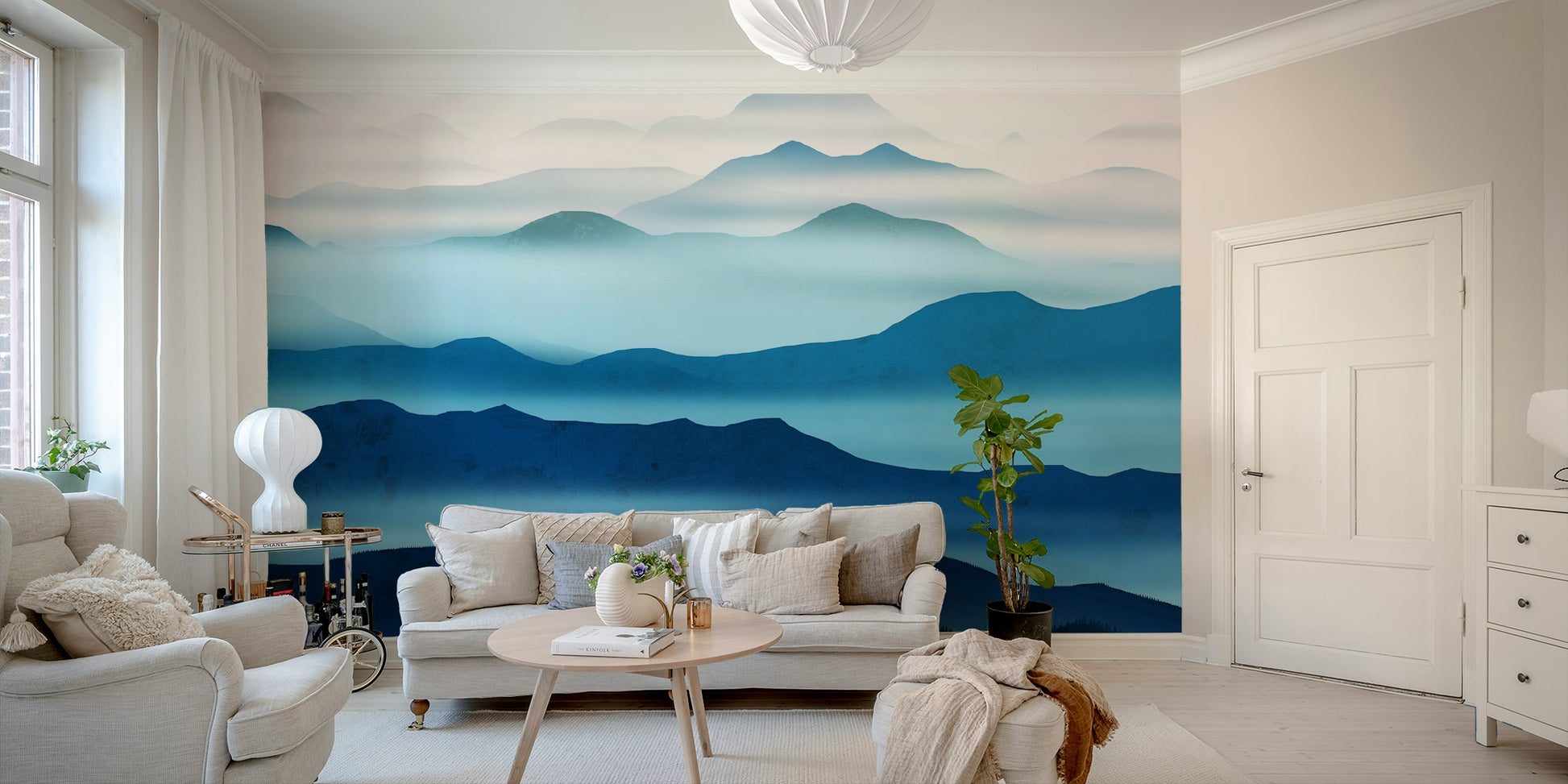 The Blue Valleys Mural Wallpaper providing a serene backdrop in a reading corner.