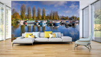 Wall mural of peaceful harbor scene with boats and trees

