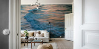 A contemporary living room with a large ocean wave wall mural.

