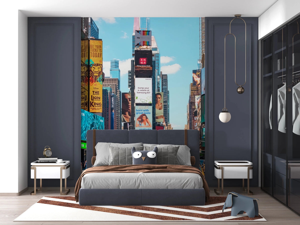 Times Square Buzz wallpaper mural of NYC billboards and skyscrapers behind a gray bed in a navy-paneled bedroom