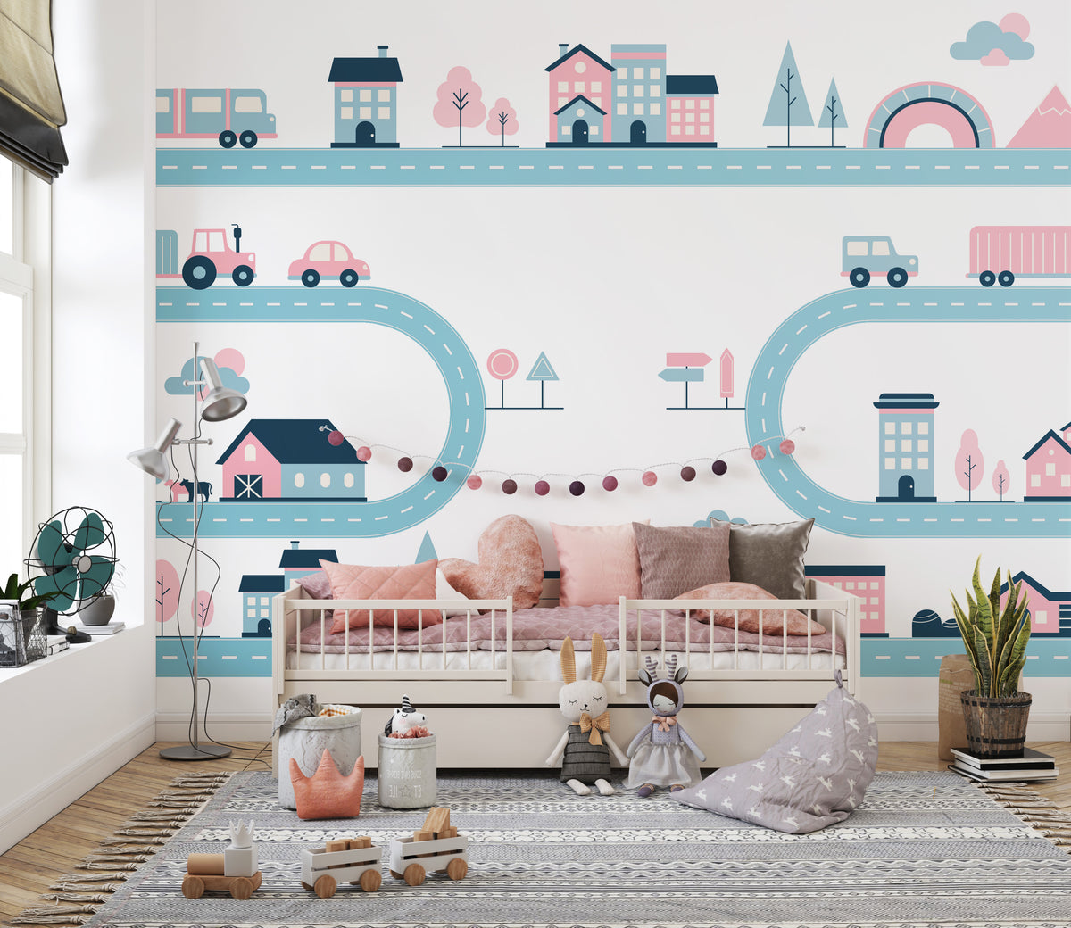 Tiny Town Urban Play wallpaper mural of pastel roads, cars and houses in pink and teal in a kids room with a daybed and toys