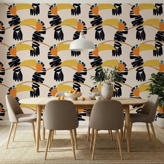 Toucans on Parade wallpaper of navy toucans on branches behind an oval wood dining table