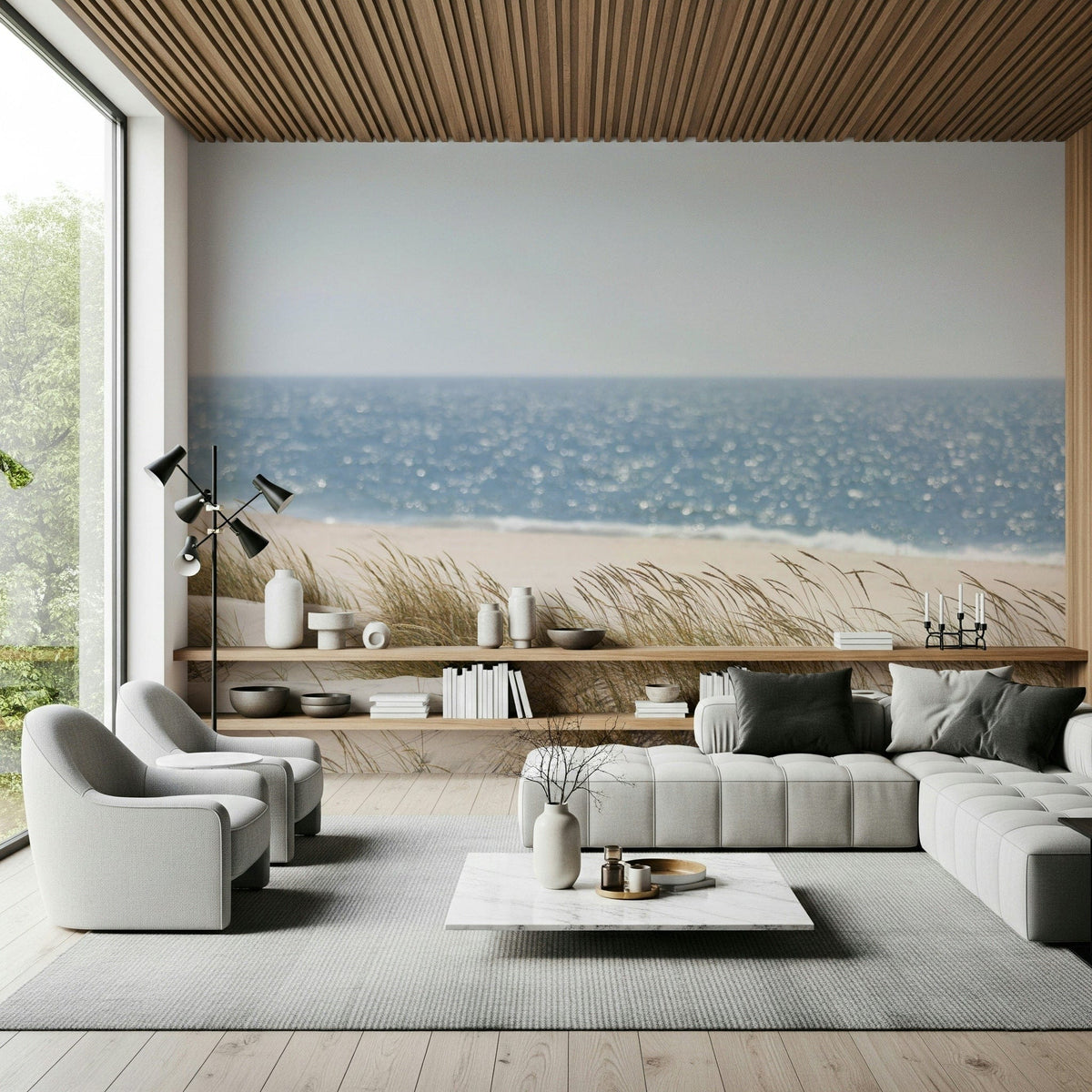 Beach Grass Hues wallpaper mural of dune grass and blue sea behind a gray sectional in a wood-ceiling living room