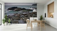 Moody ocean coastline mural behind sofa