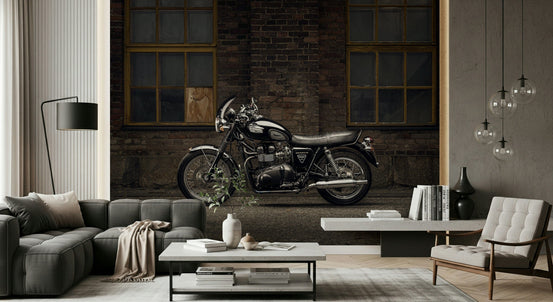 Bonneville Ride wallpaper mural of a black Triumph motorcycle by a brick wall behind a grey sofa in a living room