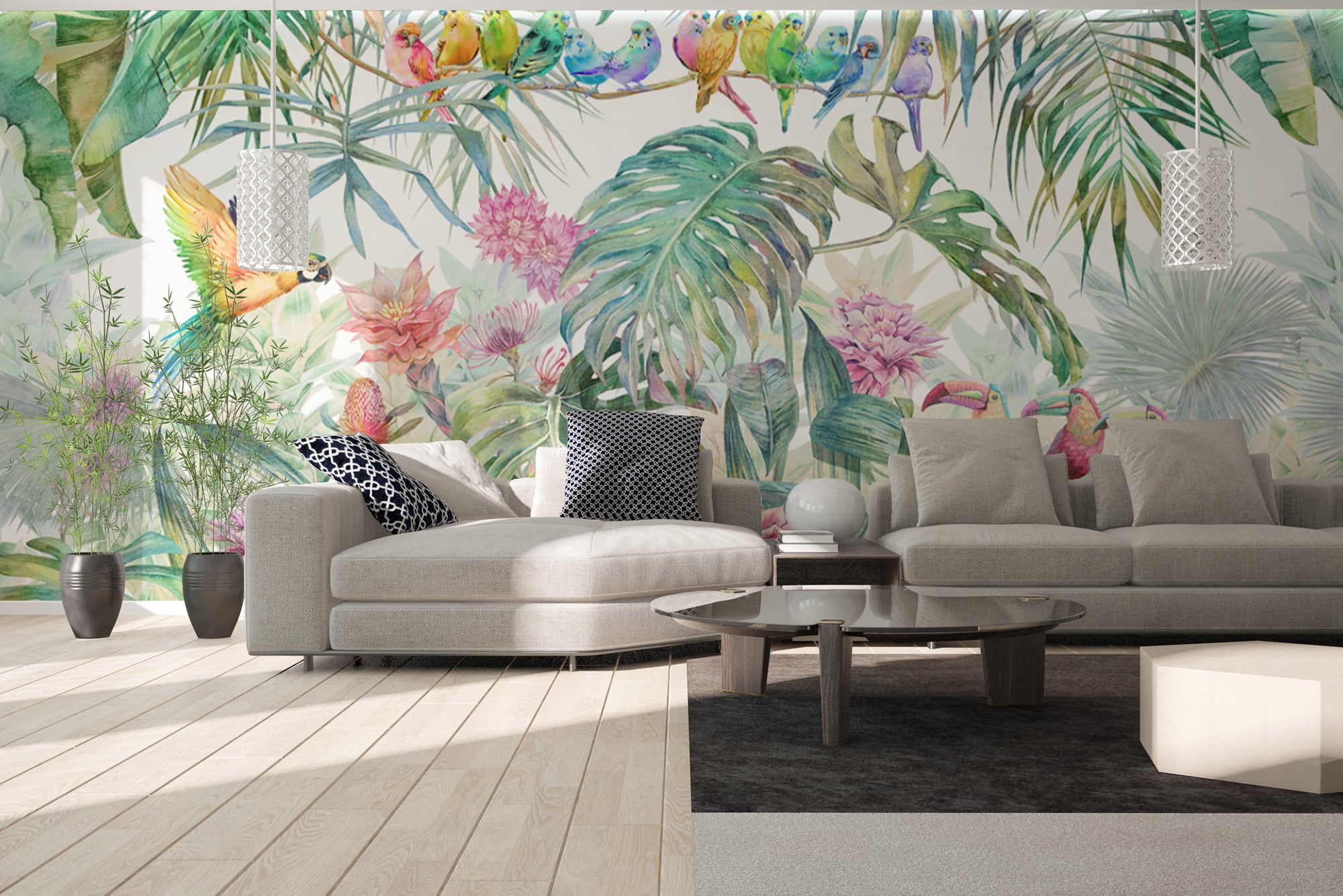 Tropical Forest Birds wallpaper mural with parrots and monstera leaves behind a grey sectional sofa in a living room