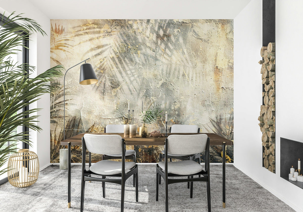 Tropical Grunge wallpaper mural with faded palm shadows on plaster behind a wood dining table and grey chairs