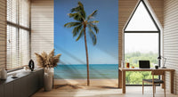 Tropical Retreat wallpaper mural of a palm and turquoise sea behind a wood desk in an A-frame home office