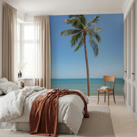 Tropical Retreat wallpaper mural of a beach palm tree behind a white bed with a rust throw in a bedroom