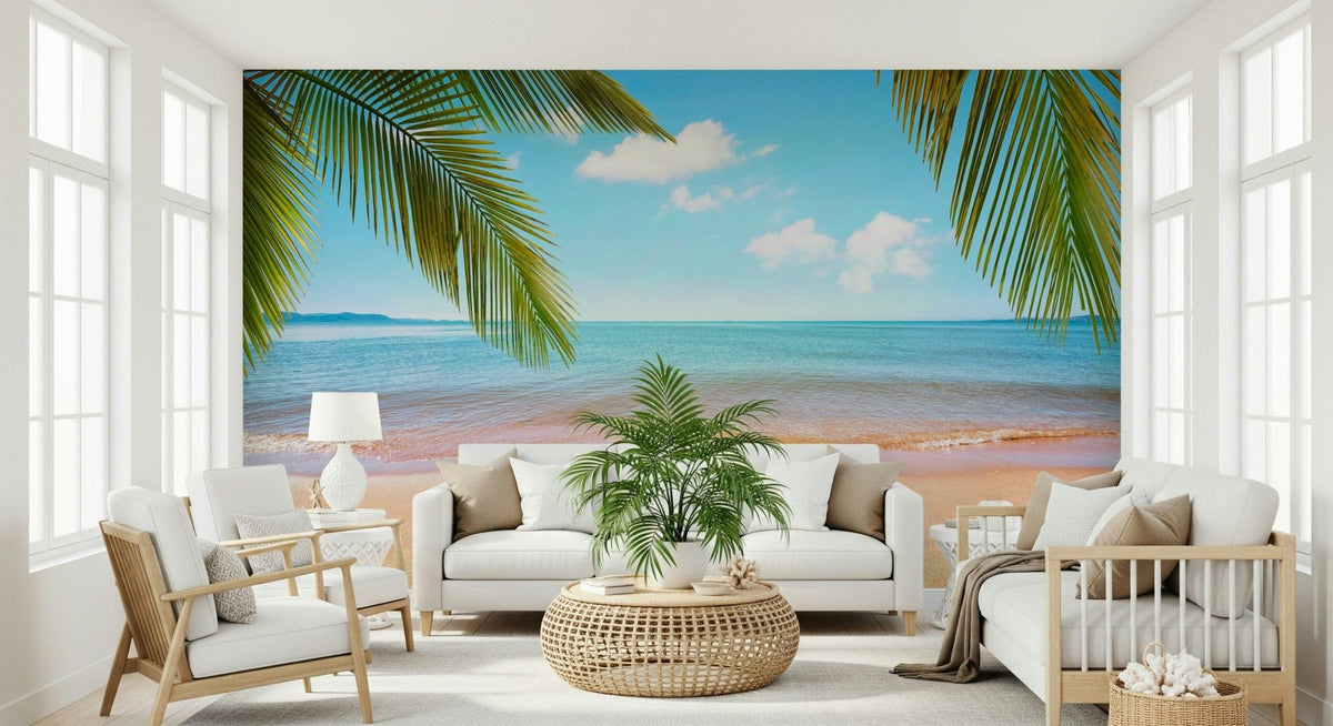 Tropical Shore wallpaper mural of a turquoise sea and palm fronds behind a white sofa and rattan table in a living room