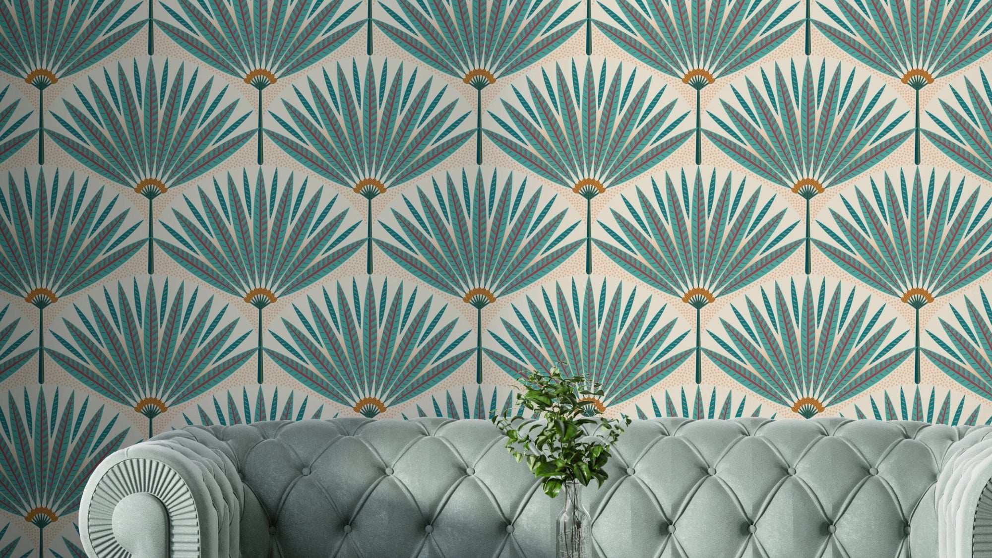 Tropical Teal Paradise wallpaper mural with Art Deco palm fans behind a tufted sage velvet sofa in a living room