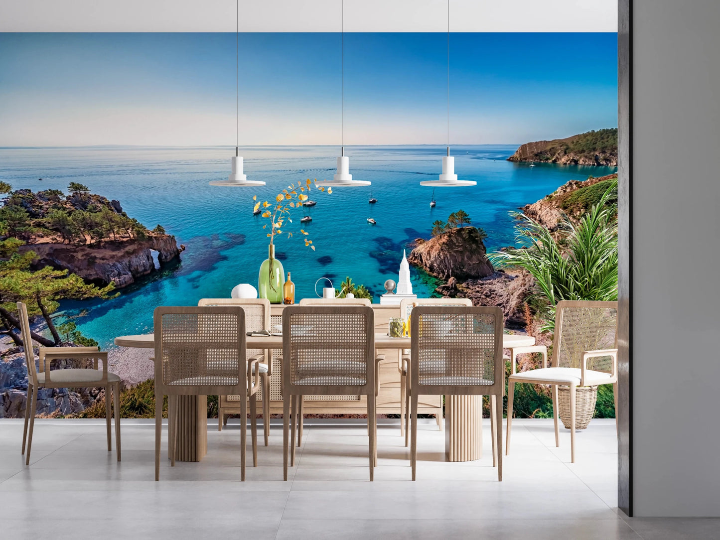 Turquoise Cove Escape wallpaper mural of a blue bay behind a wood dining table with cane chairs
