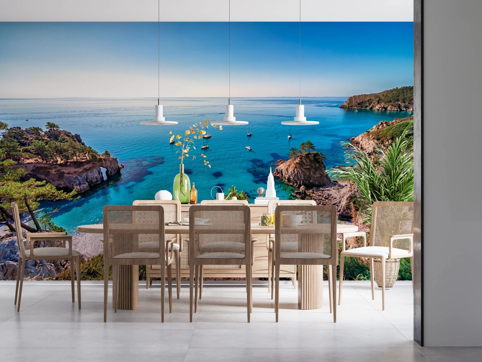 Turquoise Cove Escape wallpaper mural of a blue bay behind a wood dining table with cane chairs