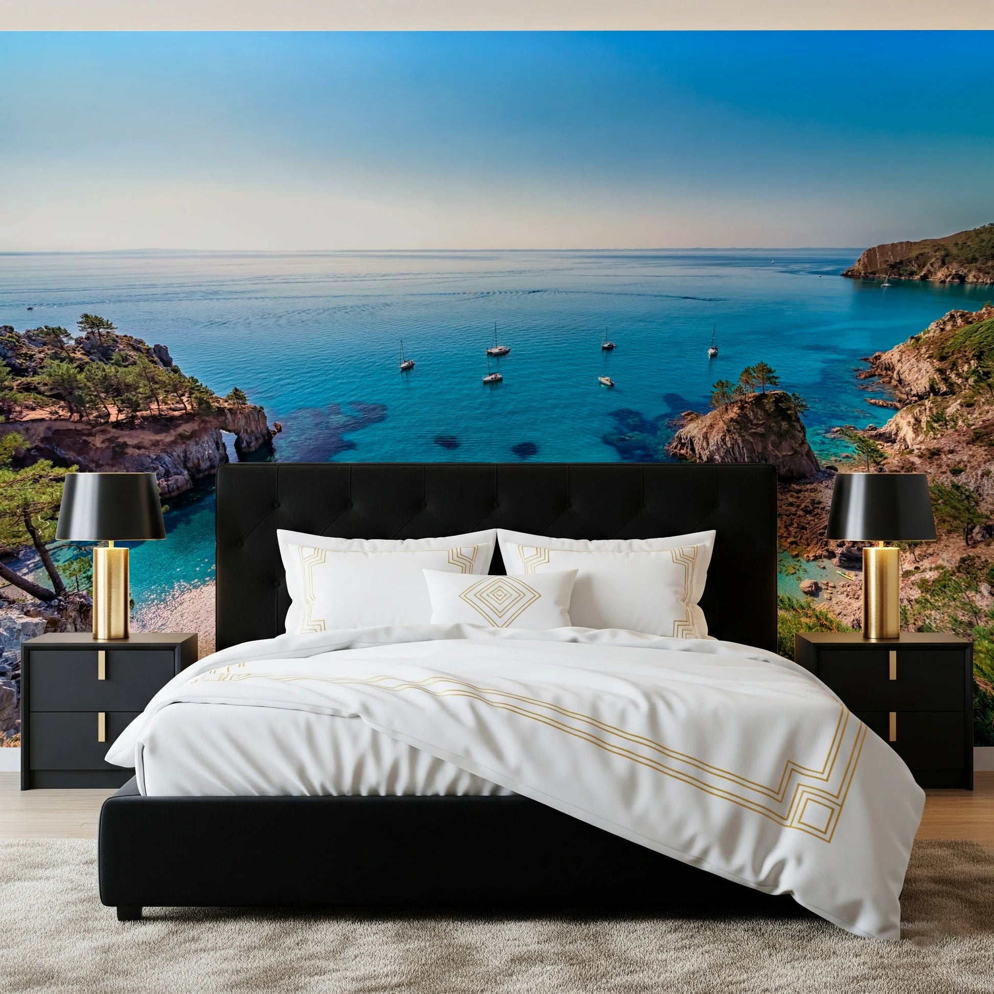 Turquoise Cove Escape wallpaper mural with rocky cliffs behind a black bed with white and gold bedding