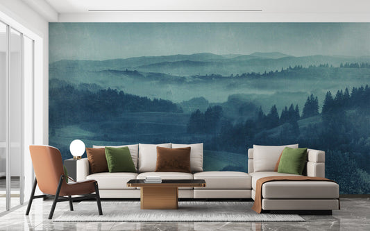 Twilight Landscape mural of misty blue-green hills behind a cream sectional sofa in a bright living room