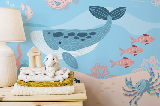 Underwater Fish wallpaper mural styled as a living room feature wall behind a sofa and seating in blue tones