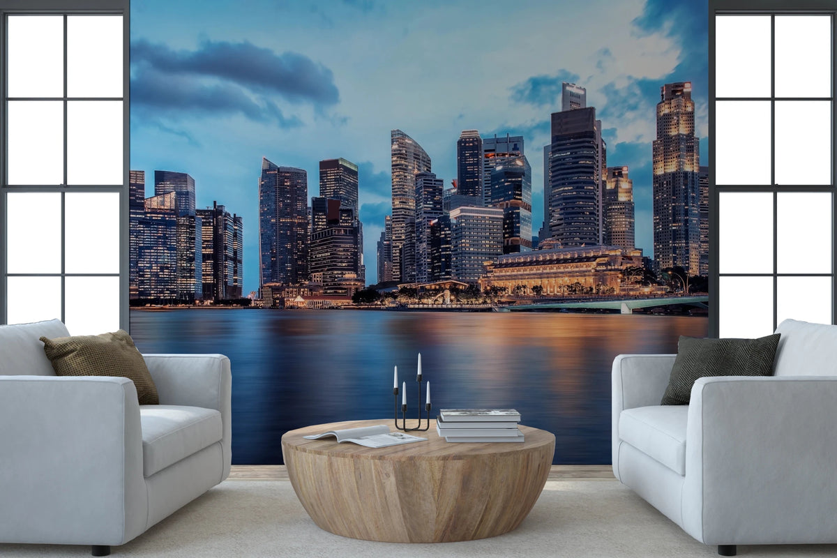 Urban Serenity wallpaper mural of a waterfront skyline under a blue sky behind two white armchairs and a round wood table