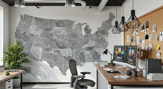 USA map with states and capitals in gray watercolor wallpaper mural beside a wood desk and dual monitors in a home office