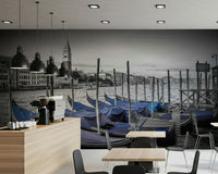 Modern apartment bedroom with Venice mural, blue water and skyline above headboard