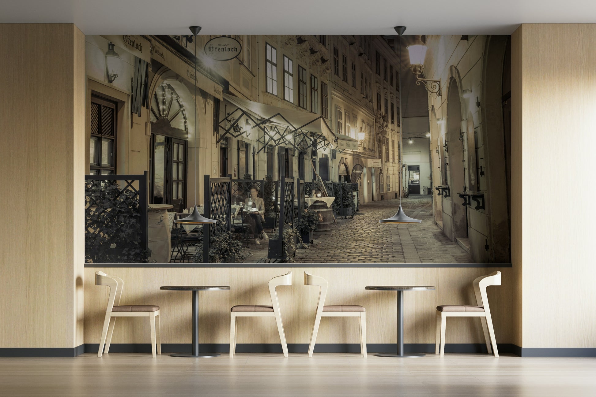 The mural shows a cobblestone street with cafes.

