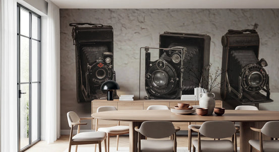 Vintage Camera Trio wall mural of three antique black cameras above a wood dining table