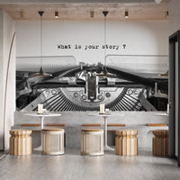 Vintage Typewriter Quote wallpaper mural reading What is your story above cafe tables and rattan stools