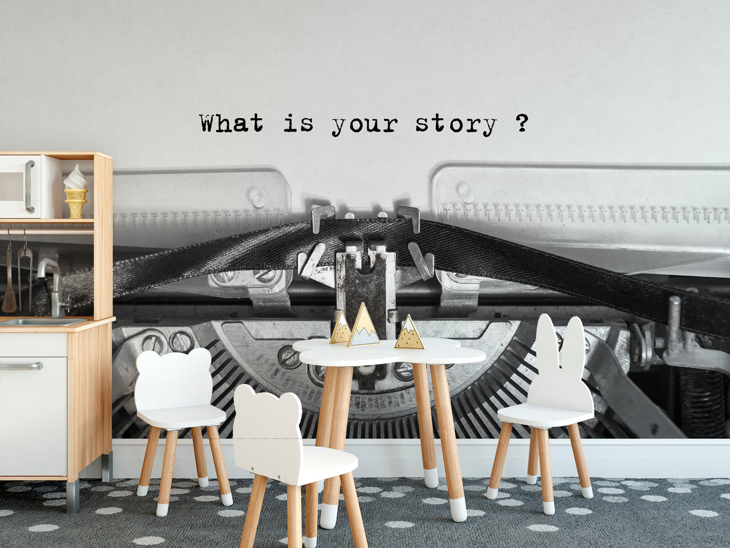 Vintage Typewriter Quote wallpaper mural behind a white kids table and animal chairs in a playroom