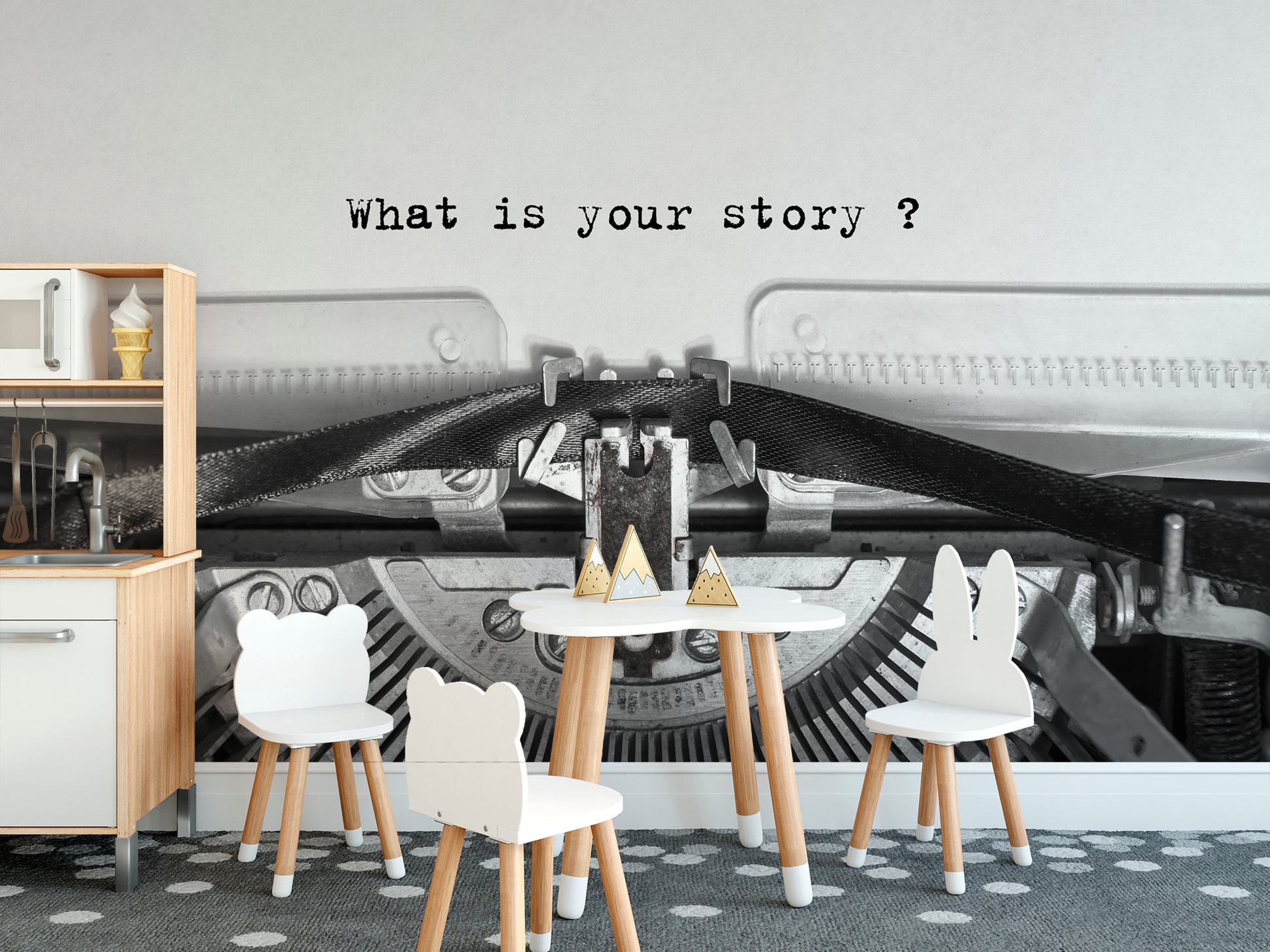 Vintage Typewriter Quote wallpaper mural behind a white kids table and animal chairs in a playroom