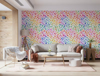 Modern boho nursery with heart print wallpaper and natural wood.