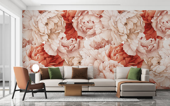 Shameless Peonies Florals mural of blush and coral blooms behind a cream sectional sofa and terracotta armchair in a living room