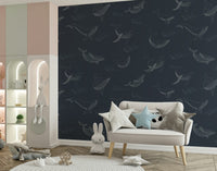 Hand-painted style whale mural in a bright sunroom with wood furniture.