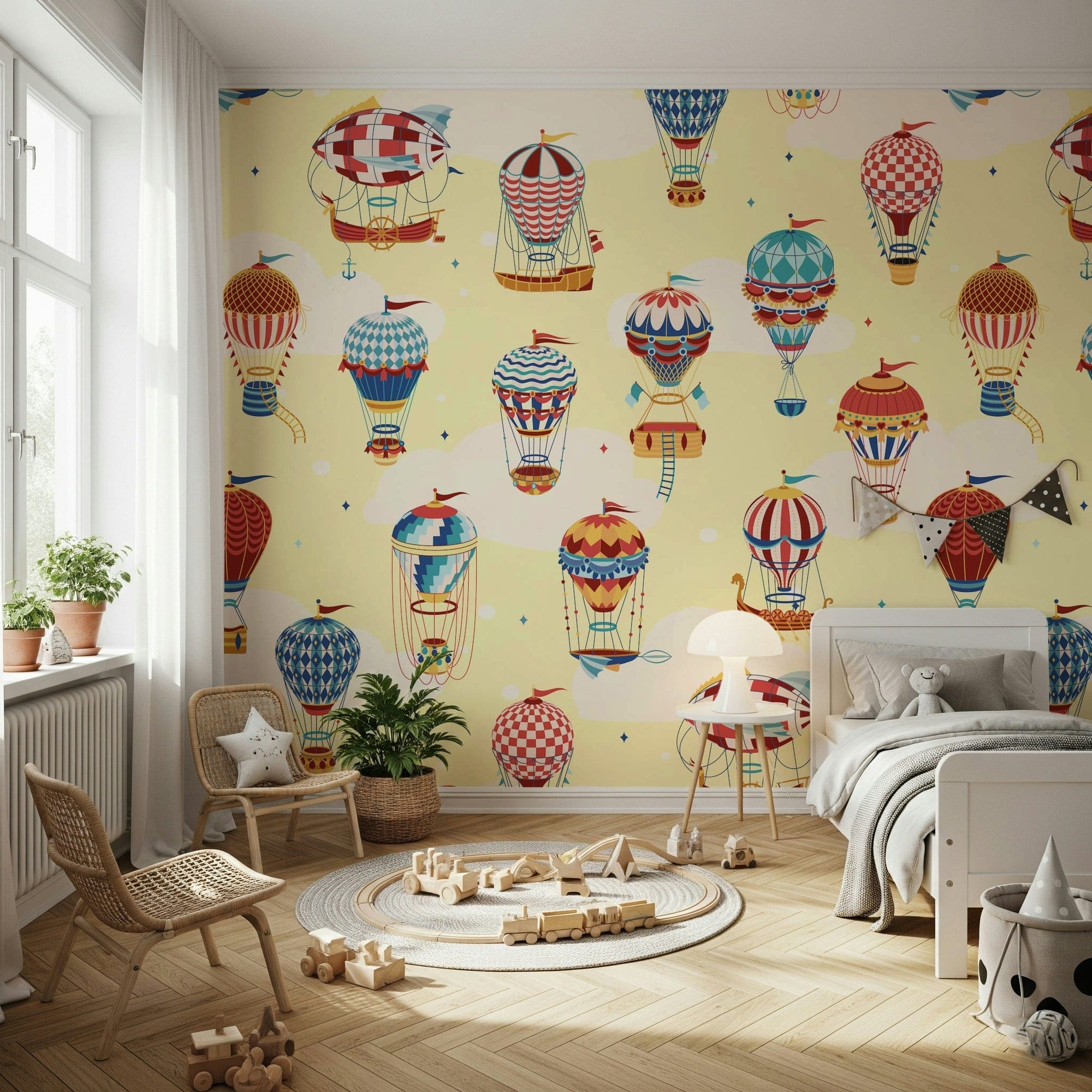 Up, Up, and Away Balloons wallpaper mural of yellow-sky balloons in a kids room with rattan chairs and a wood train toy