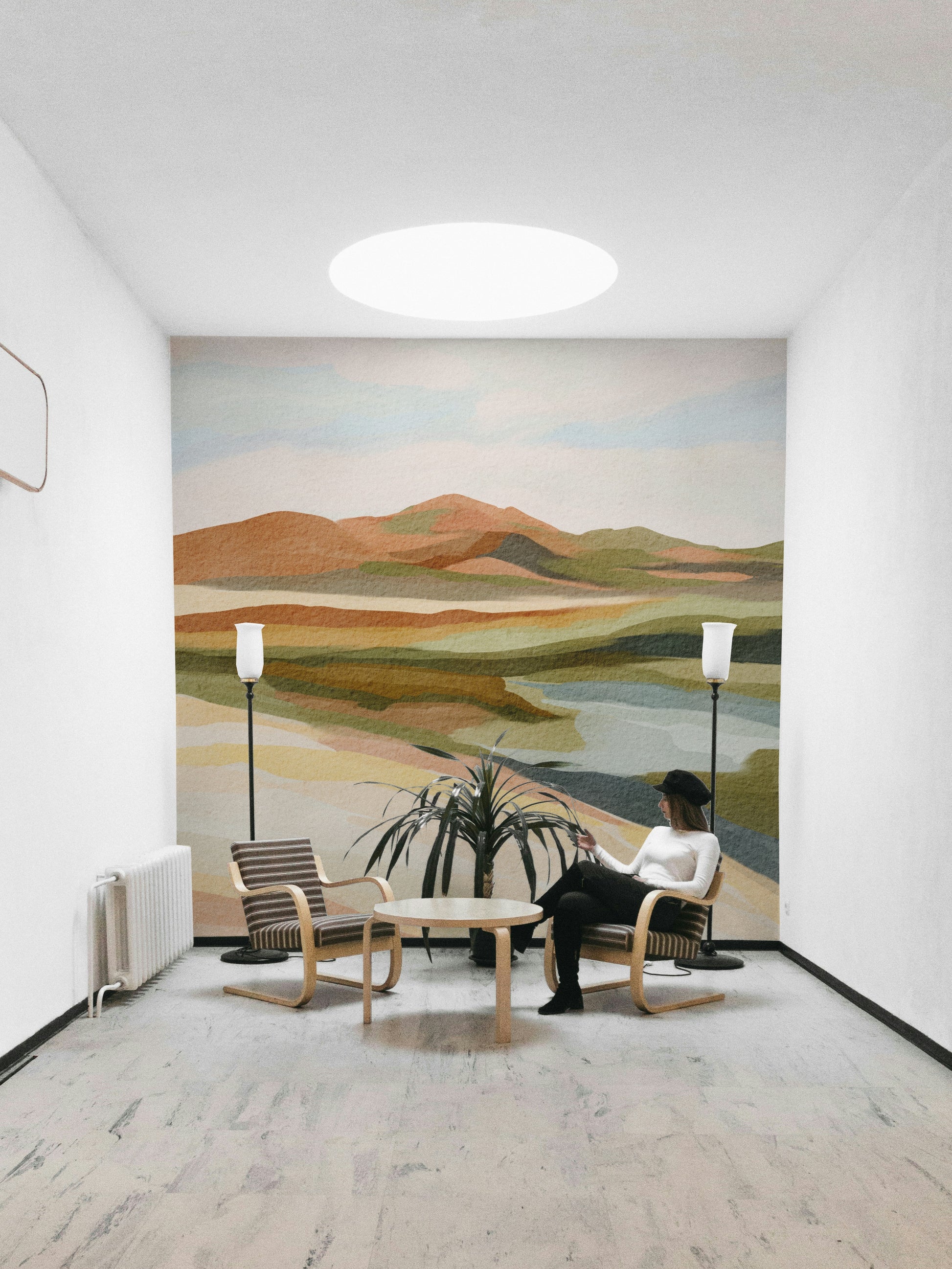 Watercolor-style hills in muted, earthy shades

