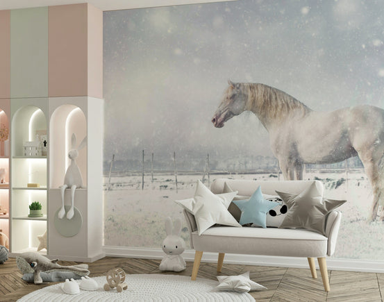 Snowdrift Horse wallpaper mural with a white horse in falling snow behind a cream loveseat in a pastel kids room