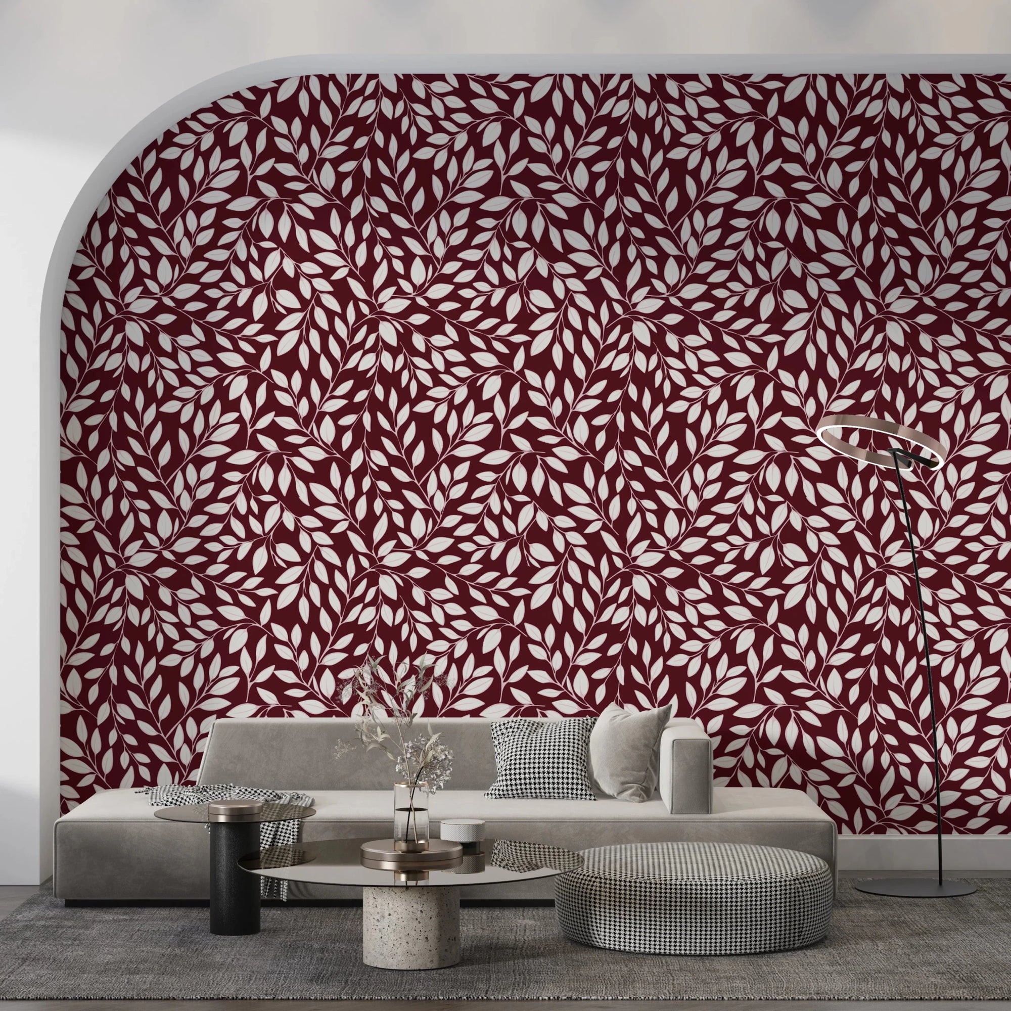 White Vines on Burgundy wallpaper on an arched wall behind a grey sofa and round travertine table