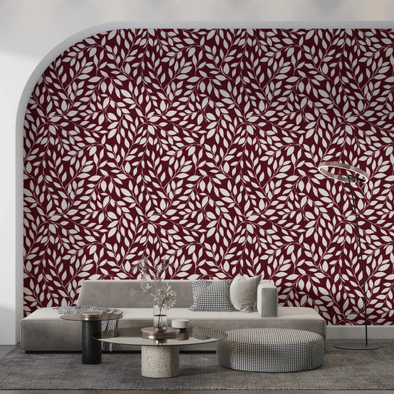 White Vines on Burgundy wallpaper on an arched wall behind a grey sofa and round travertine table