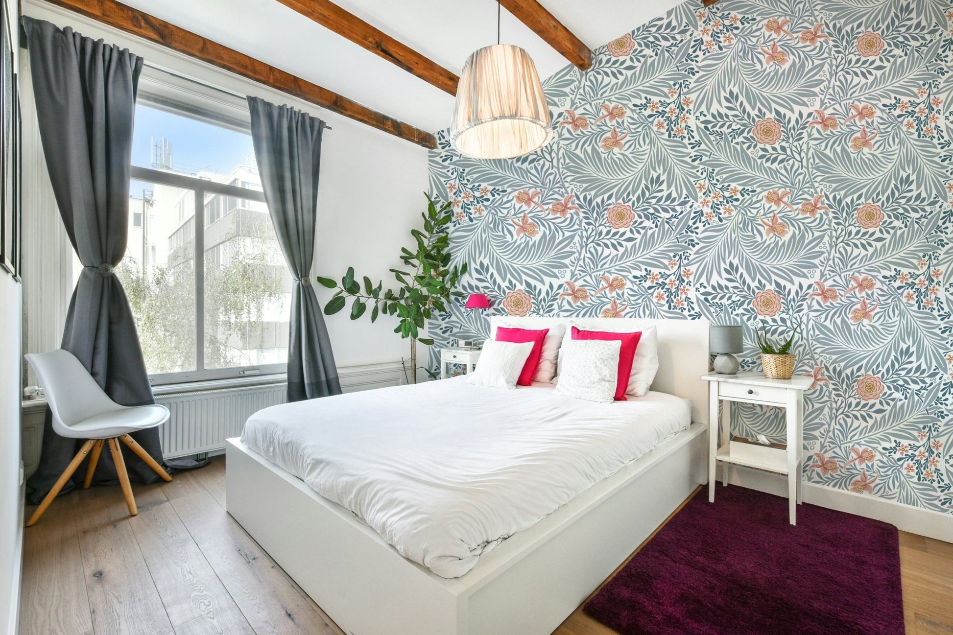 The image shows a repeating design of larkspur flowers and leaves.

