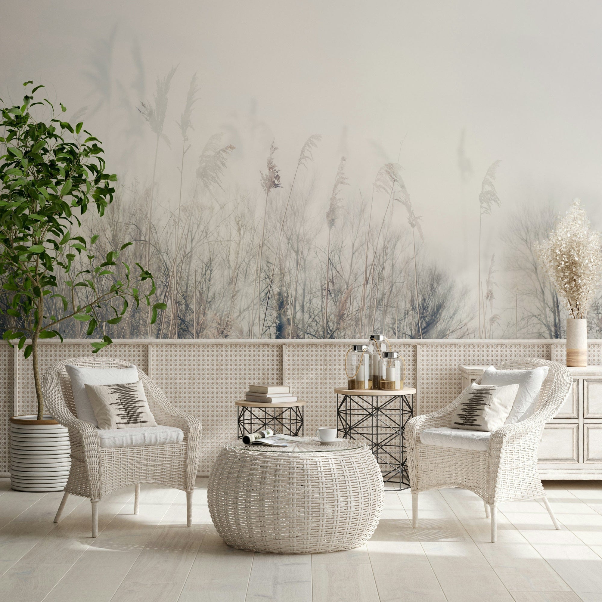 Winter Whispers wallpaper mural of pale misty reeds behind two white wicker chairs and a rattan table in a sunroom