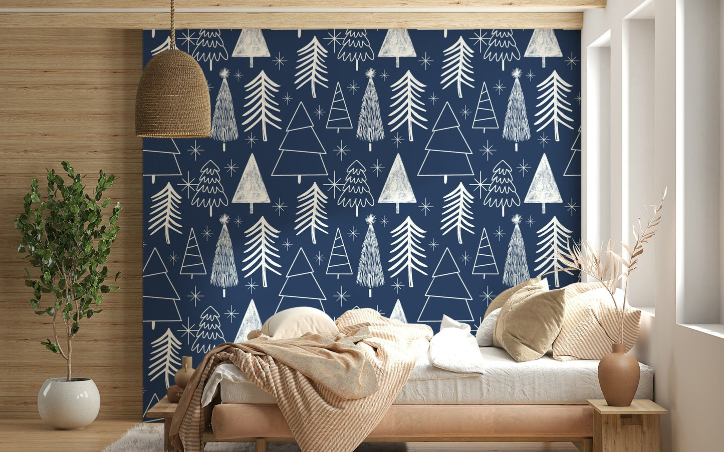 Minimalist tree illustrations and bright stars forming a festive pattern on navy wallpaper.