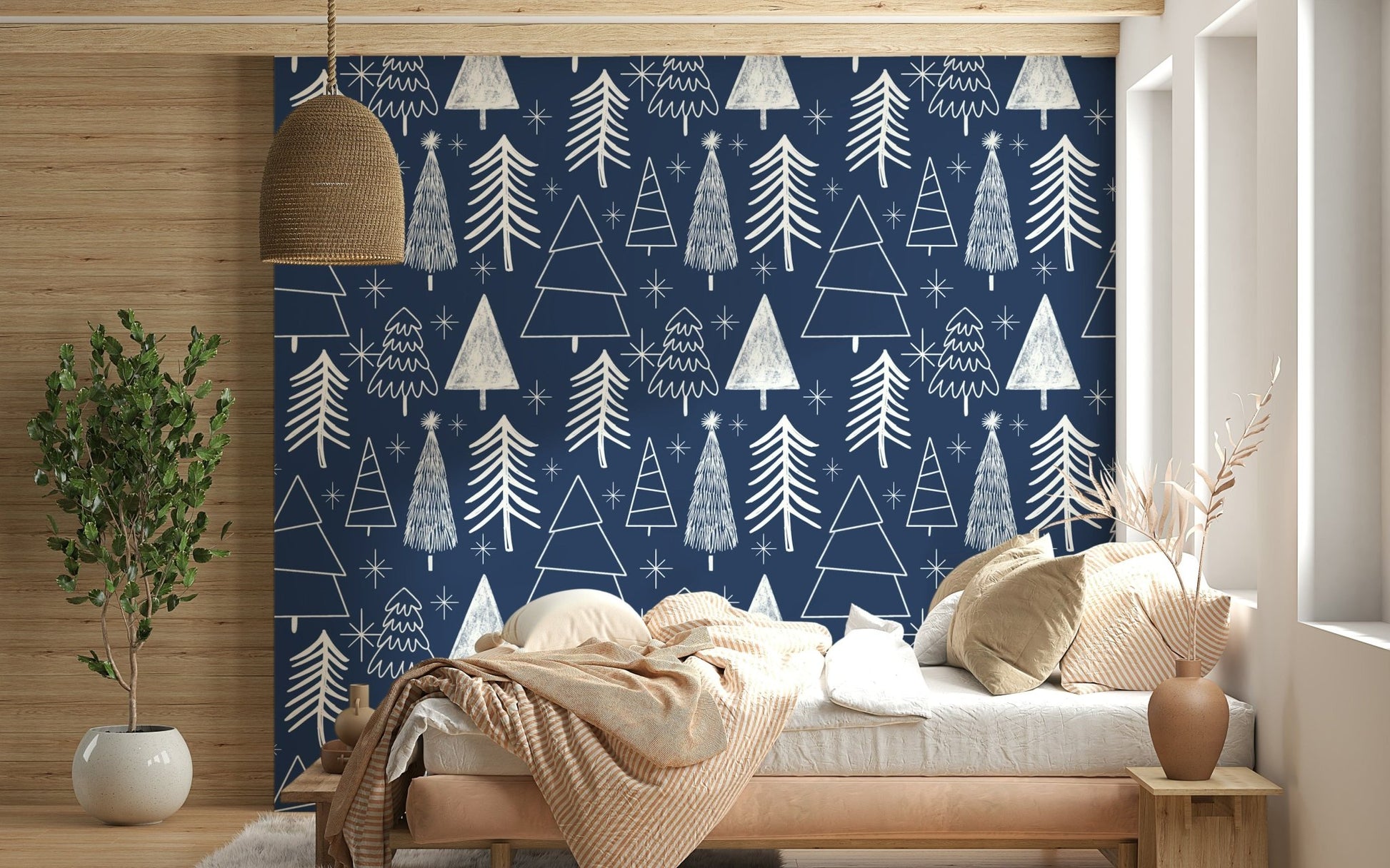Minimalist tree illustrations and bright stars forming a festive pattern on navy wallpaper.
