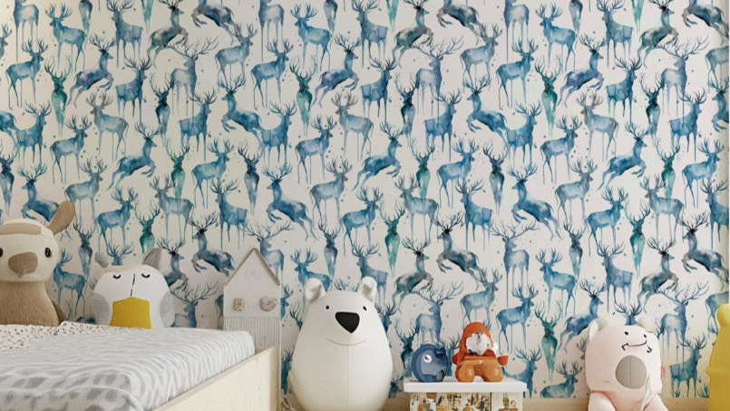 Wintery Artistic Deers Blue Wallpaper in a modern living room with gray furniture.