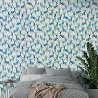 Blue artistic deer wall mural paired with light wood furniture in a den.