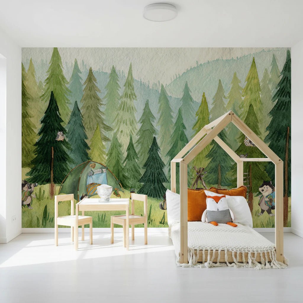 Woodland Wolf Camp wallpaper mural of green watercolor pine forest with camping wolves above a house-frame kids bed with fox cushion
