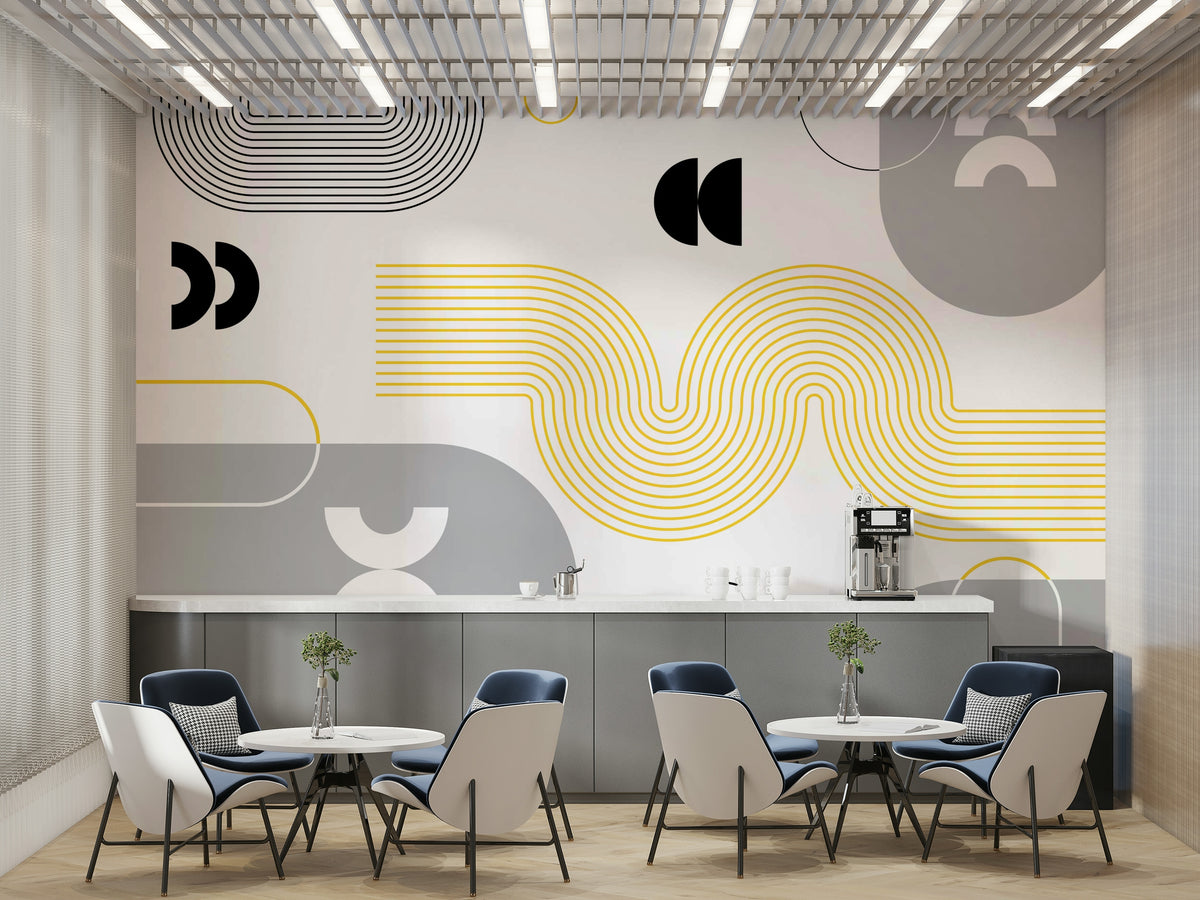 Yellow and Gray Geometric mural with yellow waves and gray shapes behind navy chairs and round tables in a cafe dining area